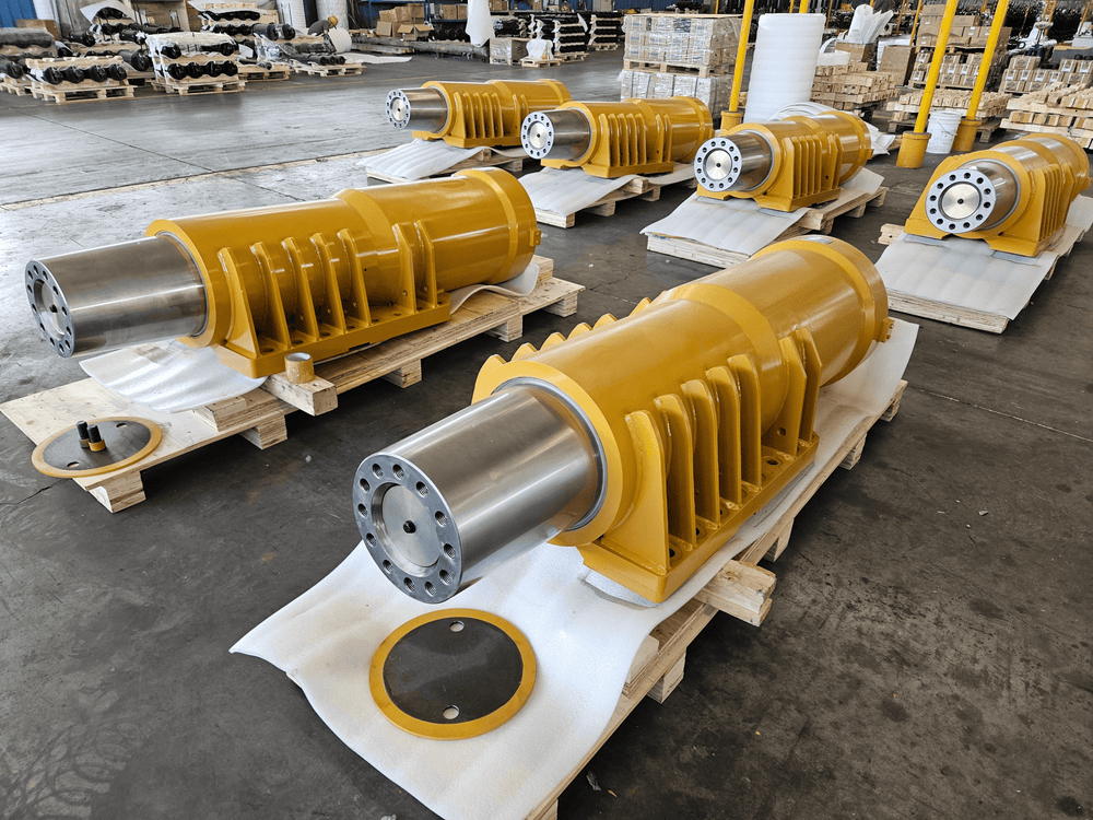 Multiple newly manufactured aftermarket Caterpillar 793 front suspension cylinders.