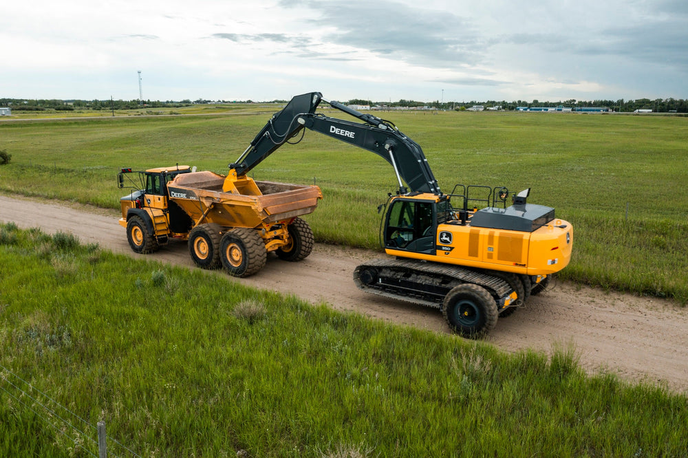 Excavator being transported on Sleipner E50 dollies / transport system, hauled by an articulated dump truck.